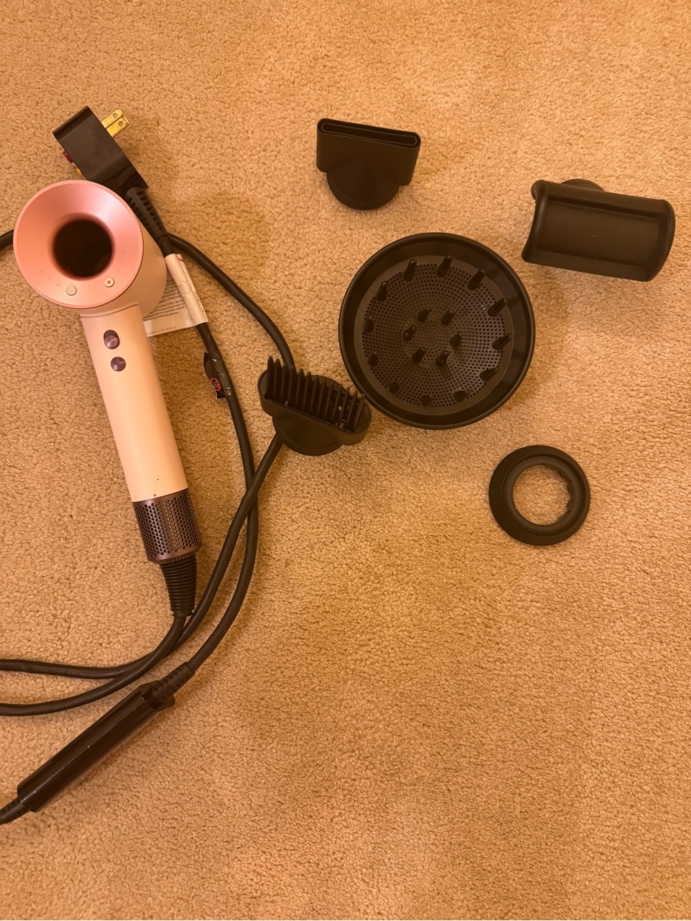 Dyson Pink Hair Dryer with Multiple Black Attachments